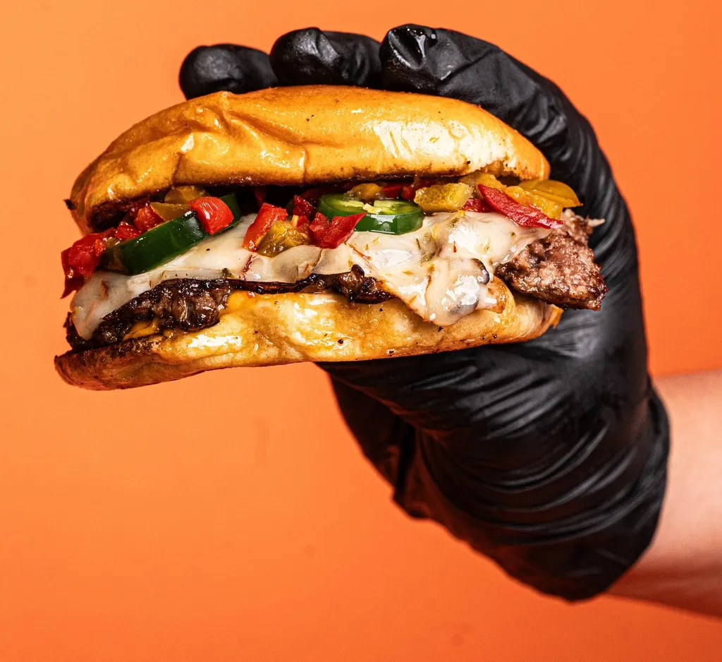 Stash Burger double smash burger held in hand
